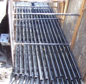 Installing black Champion fiberglass conduit in deep trench