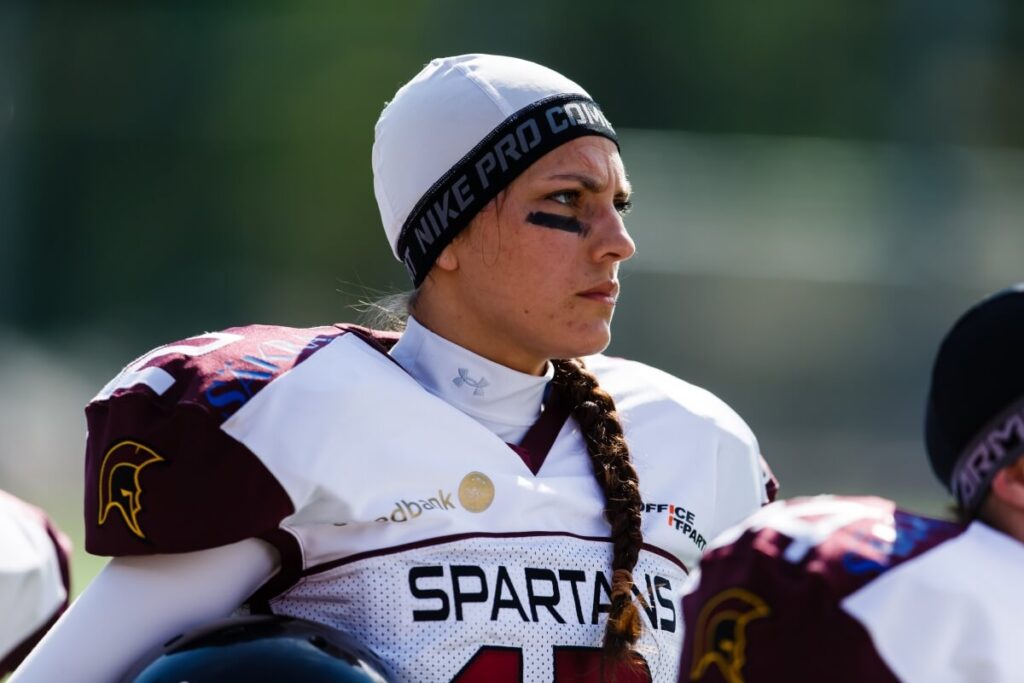 Female Spartans player wearing beanie with eye black.