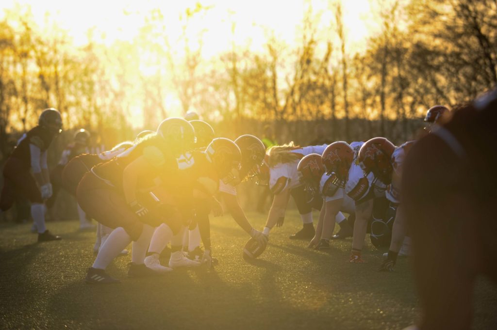 American football scrimmage line under intense golden light