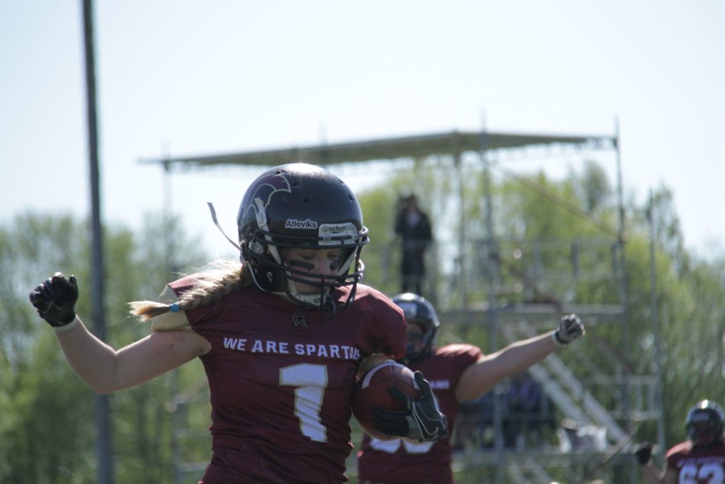 Female football player celebrating victory on the field