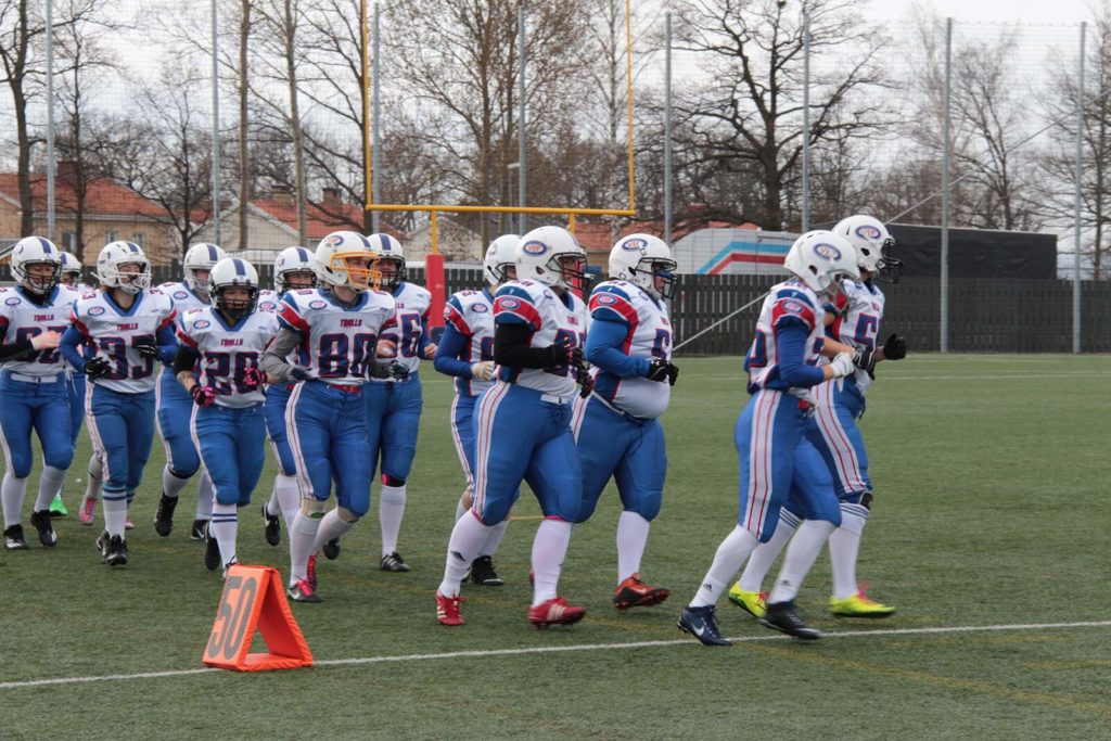 wp female football players jogging across green field