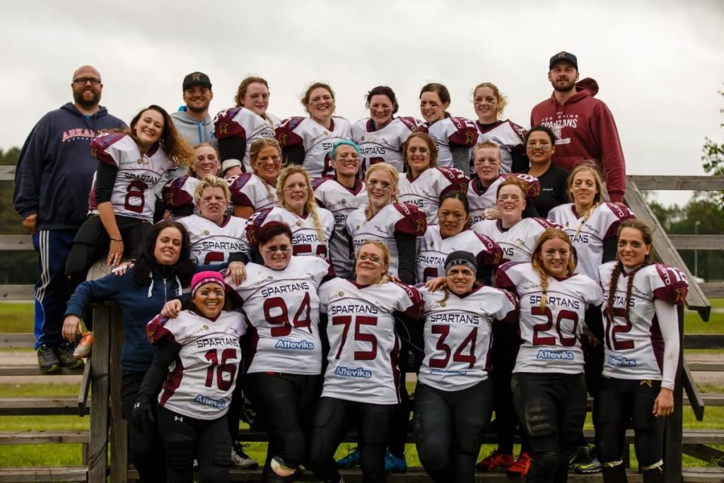 Smiling Spartans womens football team group portrait.