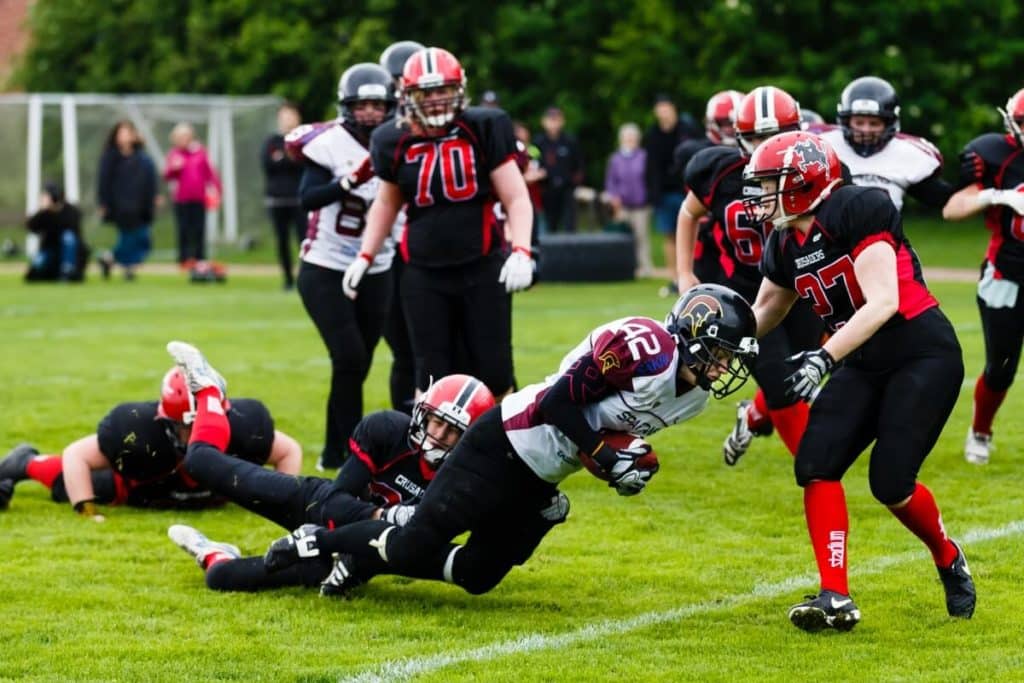 Intense womens tackle football game action on grass
