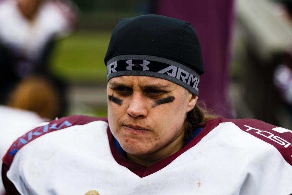 Intense athlete wearing eye black and Under Armour