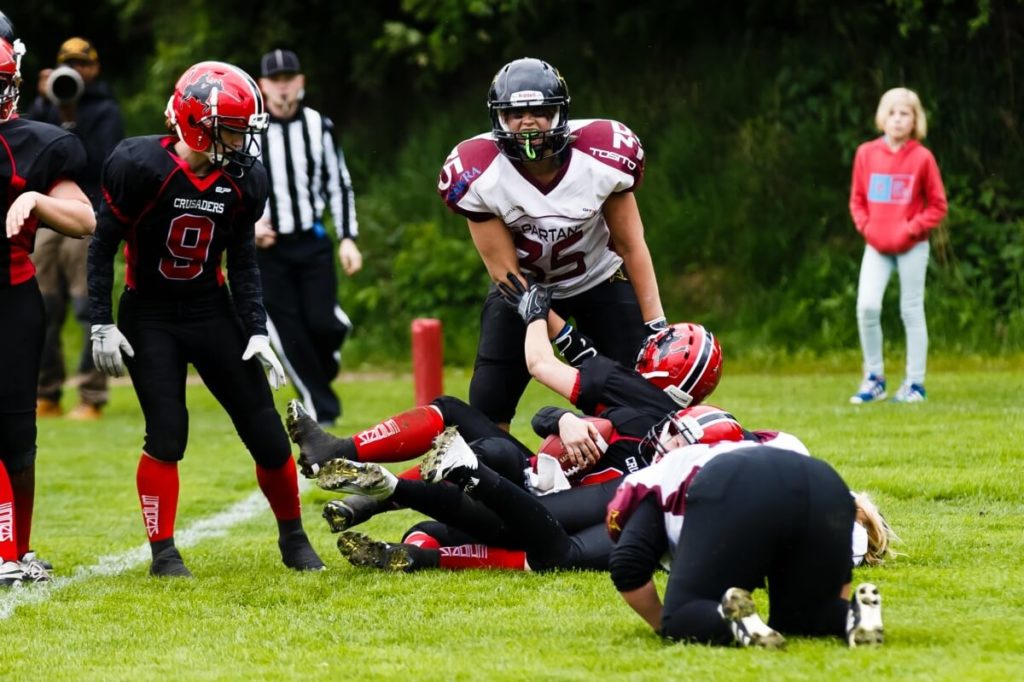 Female football players tackling during intense outdoor match