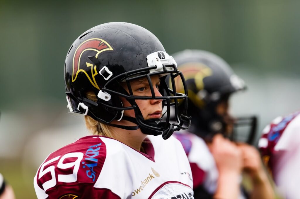 Athlete wearing black helmet with maroon gold logo
