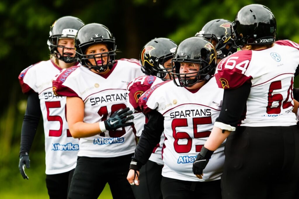 Spartans female athletes in maroon and white jerseys.