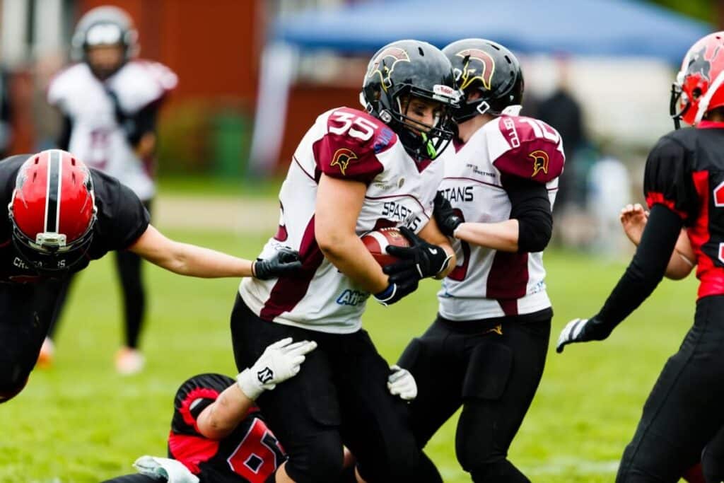 Female football player running with the ball
