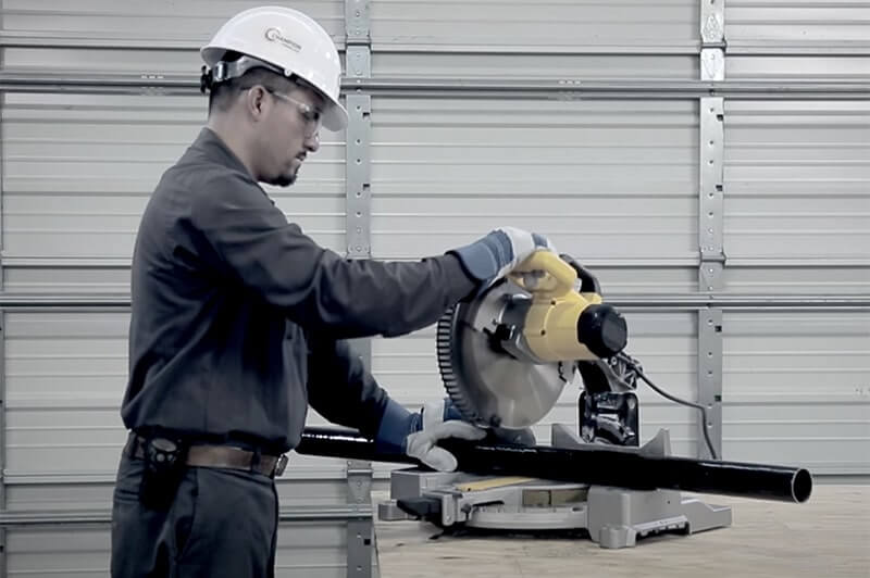 A chop saw cuts fiberglass conduit