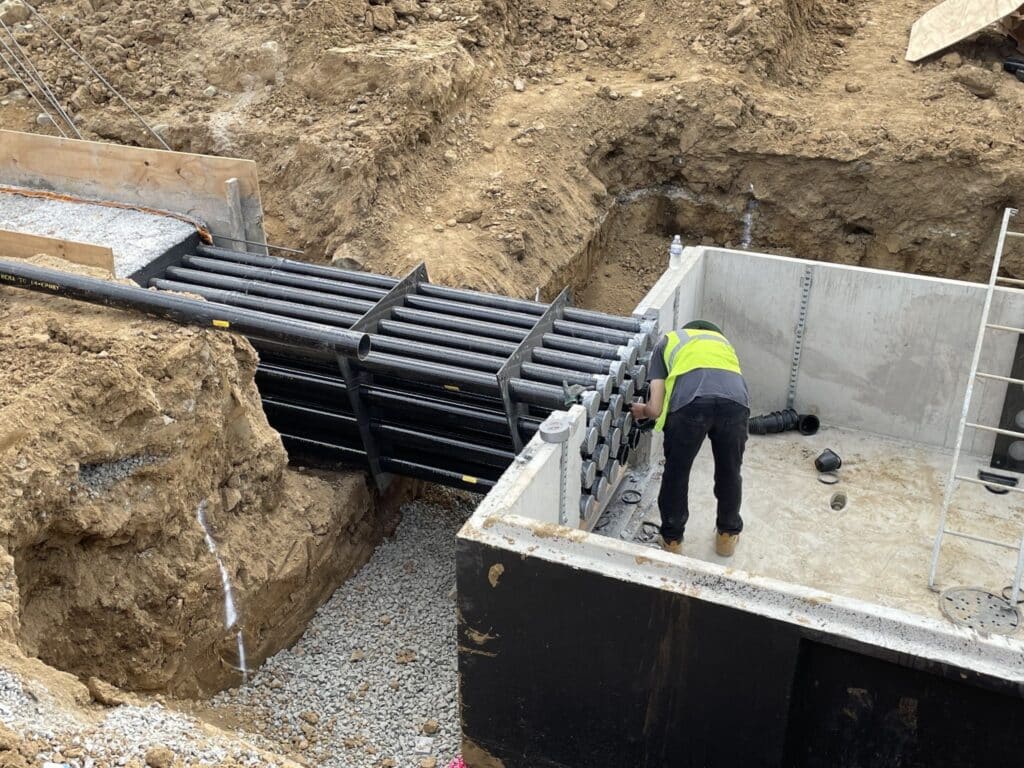 A duct bank terminates into a concrete vault.