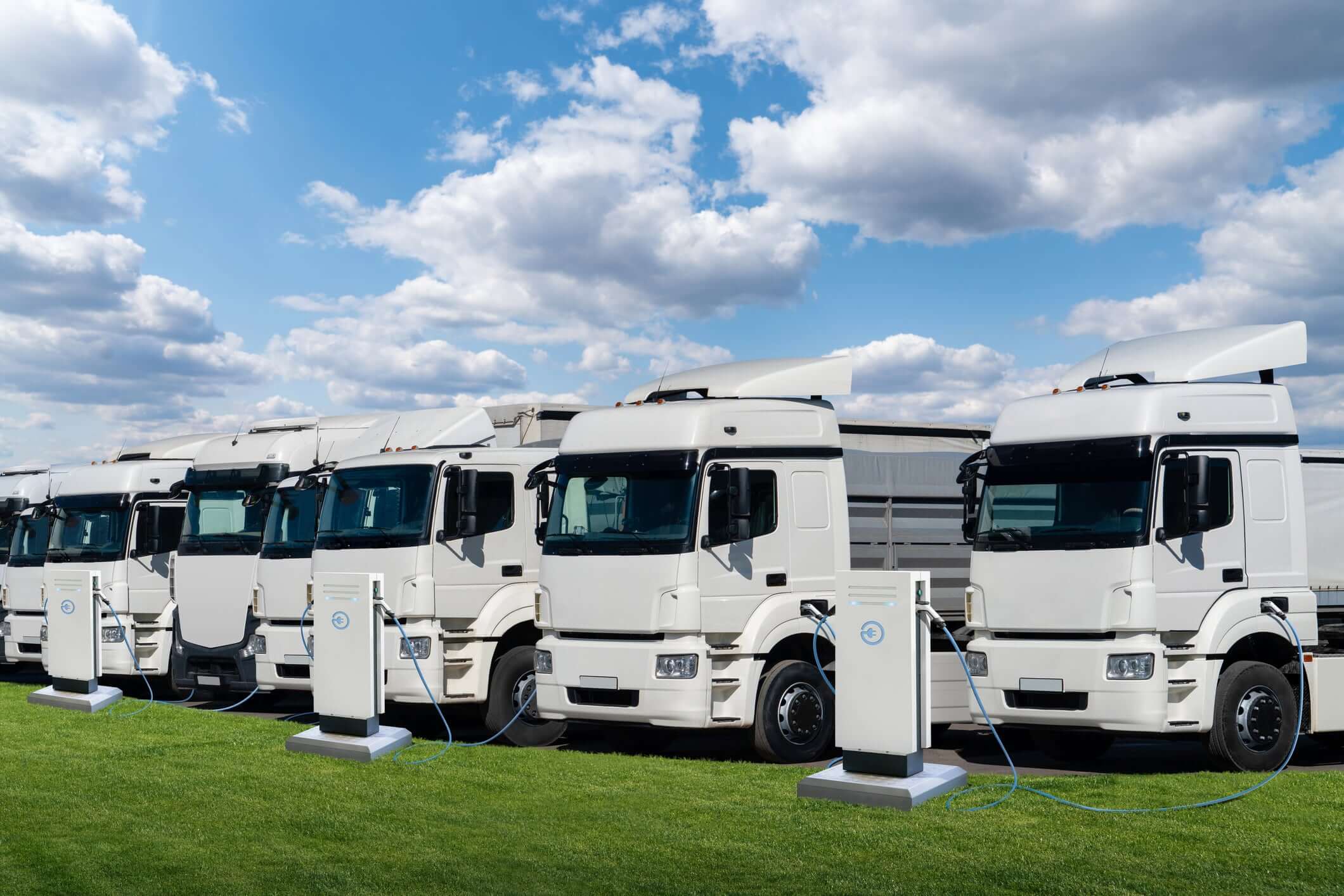 White semi-truck fleet charging using electrical conduit.